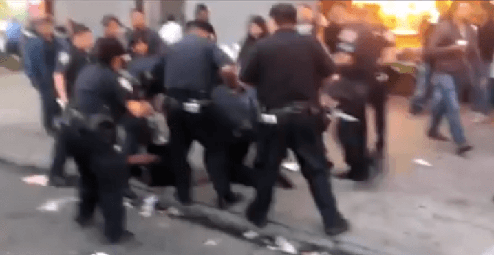 officer kicking street vendor